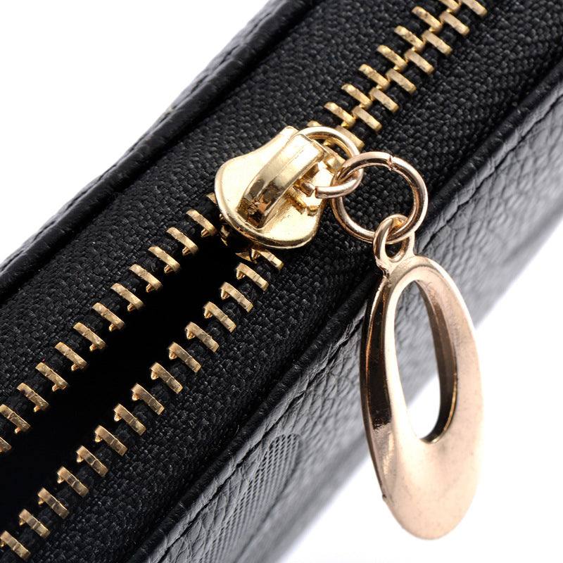 Close-up of zipper detail on Ladies Leather Floral Wallet showing gold zipper and pull tab.