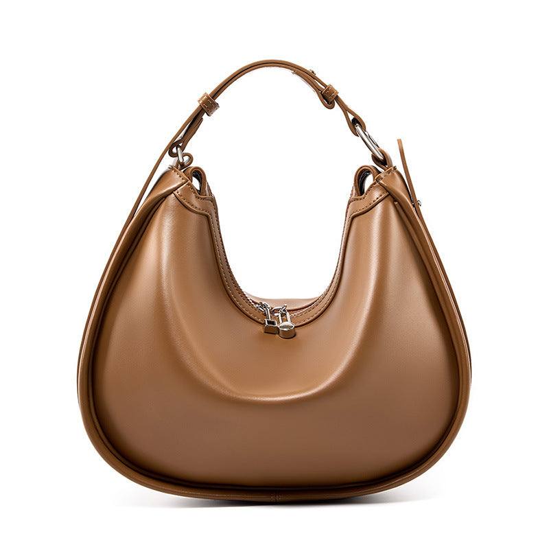 Smooth leather crescent handbag with adjustable strap and sleek design, showcasing timeless style and practicality