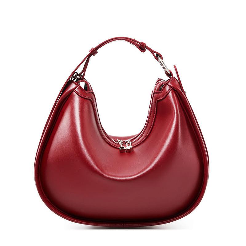 Smooth Leather Crescent Handbag in sleek crescent shape with adjustable strap, genuine leather, and multiple pockets.