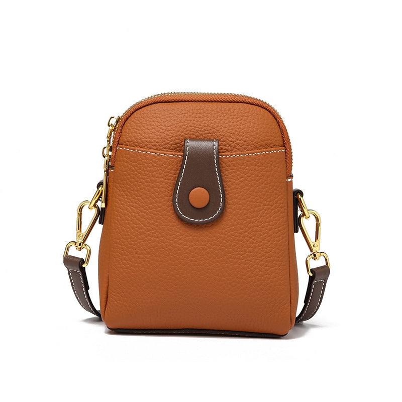 Leather phone pouch with adjustable strap and multiple compartments, crafted from genuine lychee-pattern leather.