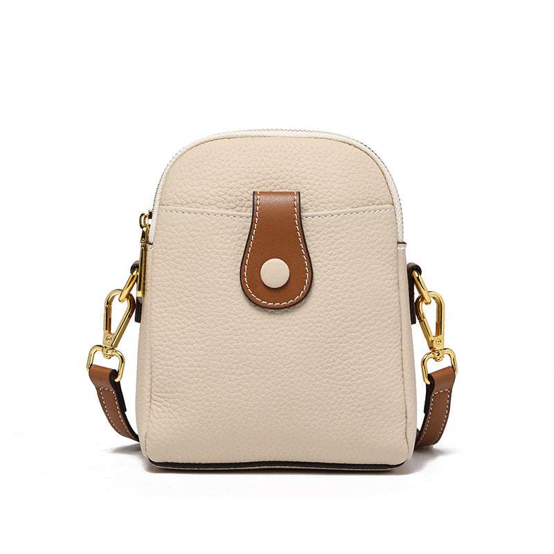 Beige leather phone pouch with a brown clasp and adjustable strap, featuring durable design