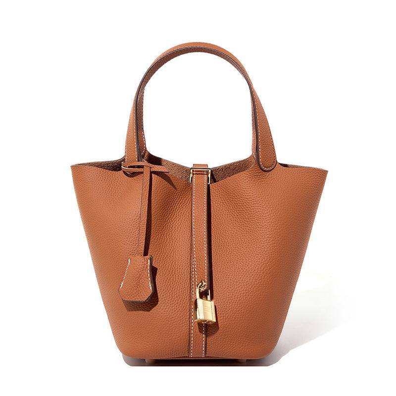Lychee Leather Basket Tote in durable genuine leather with a modern silhouette, featuring a signature lock and removable