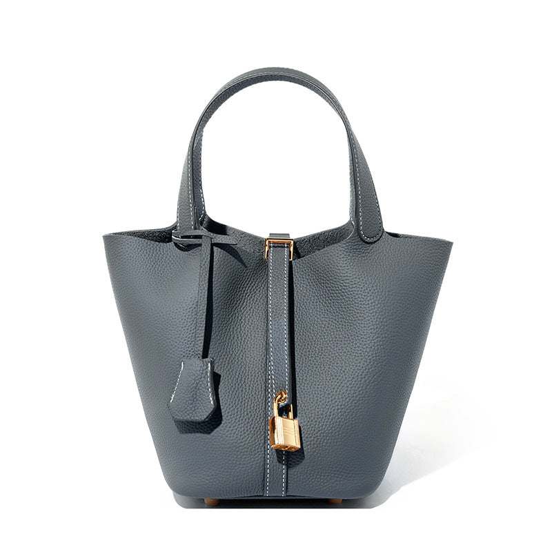 Lychee Leather Basket Tote in durable gray leather with a modern silhouette and signature lock.
