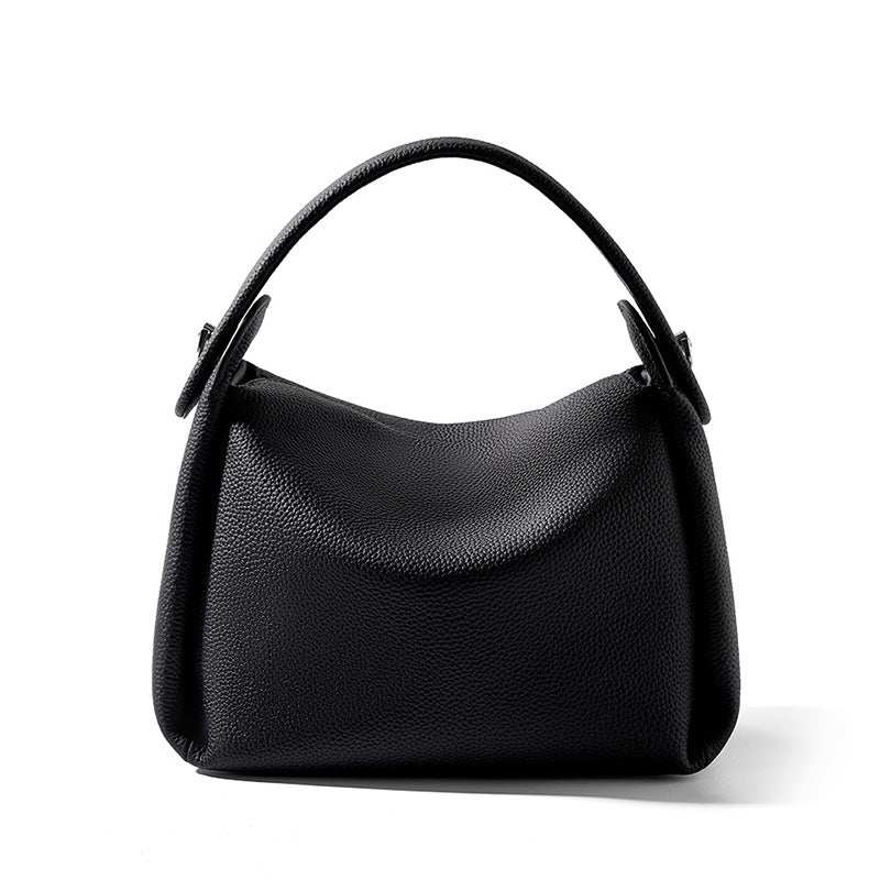 Modern soft leather handbag with adjustable strap and smart storage options, crafted from
