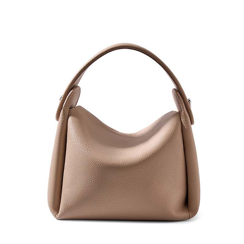 Modern soft leather handbag in taupe with adjustable strap and smart storage, perfect for everyday