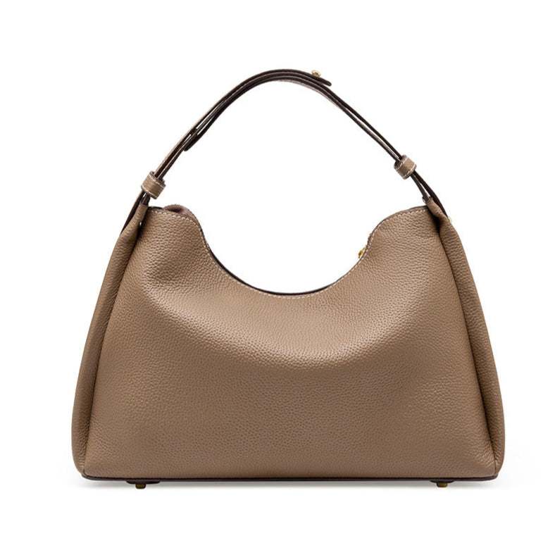 Trapezoid-shaped leather crossbody handbag with lychee-patterned texture and adjustable strap.