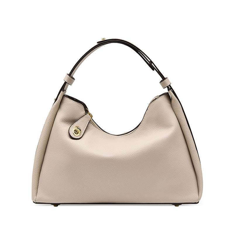 Trapezoid leather crossbody handbag with adjustable strap, featuring lychee-patterned scratch-resistant leather hardware