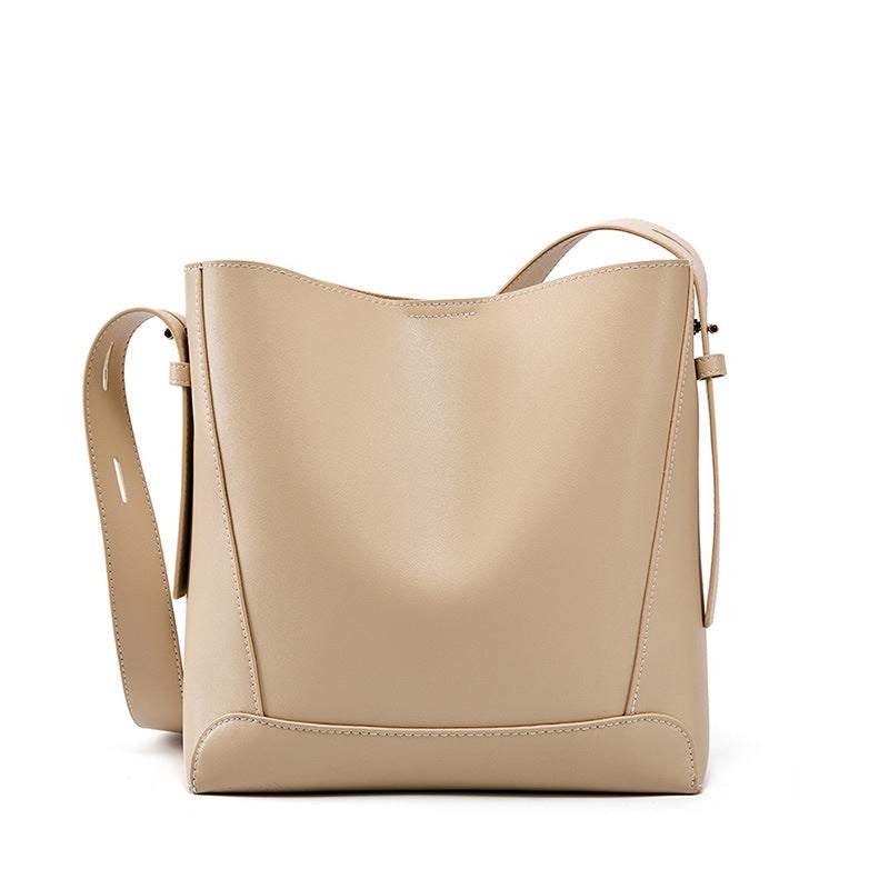 Beige genuine leather bucket tote purse with single shoulder strap.