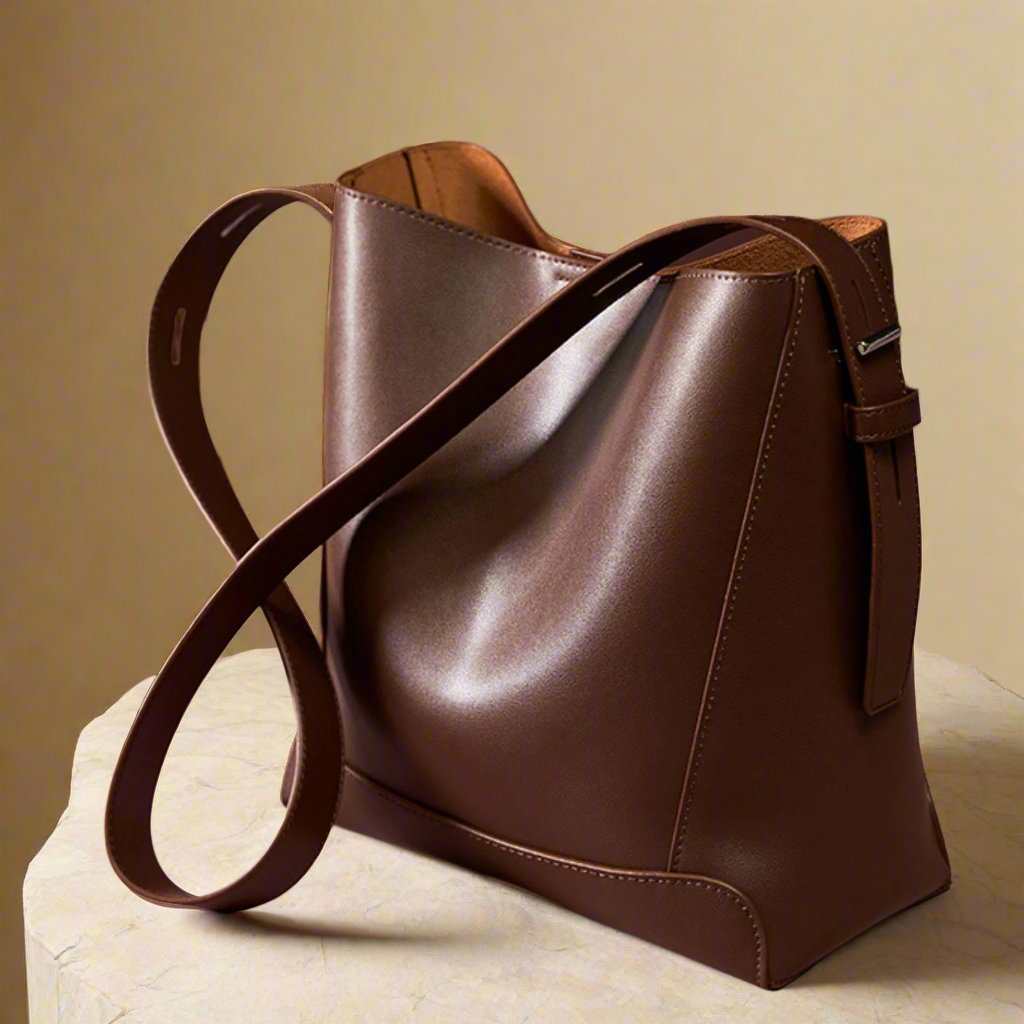 Brown genuine leather bucket tote purse with long strap and elegant design, ideal for daily use.