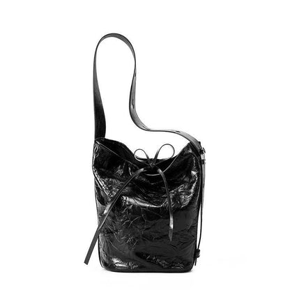 Burgundy Bucket Bag made of genuine leather with wrinkled texture, tie closure, and shoulder strap.