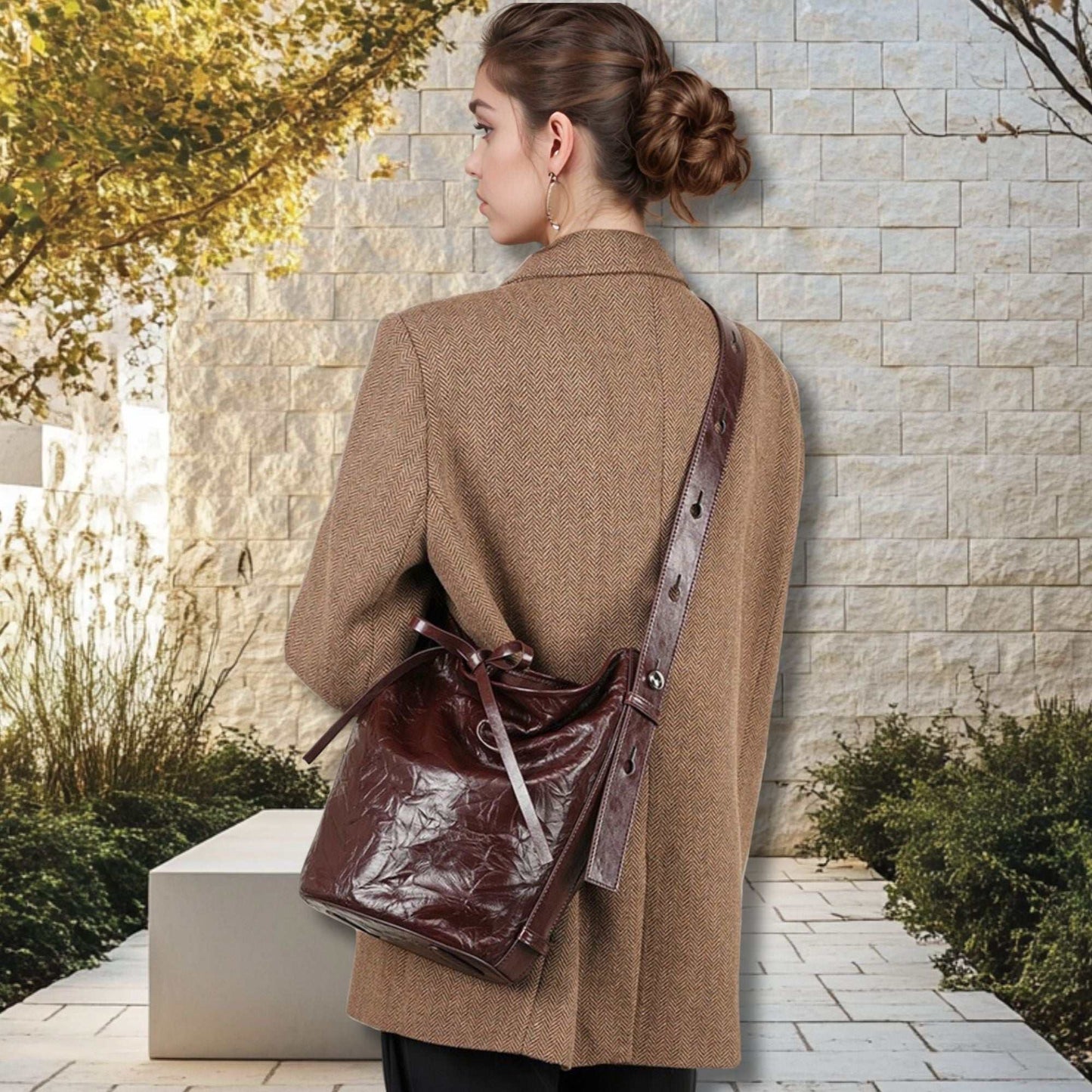 Burgundy Bucket Bag in genuine leather with elegant wrinkled pattern, shown on a person wearing a coat.