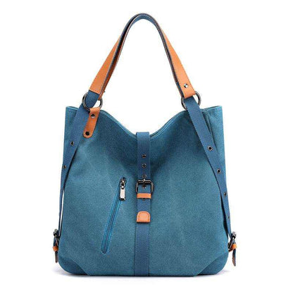 Convertible backpack purse with blue canvas and brown vegan leather accents.