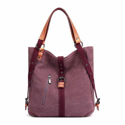 Convertible backpack purse handbag in maroon canvas with vegan leather accents and adjustable straps.