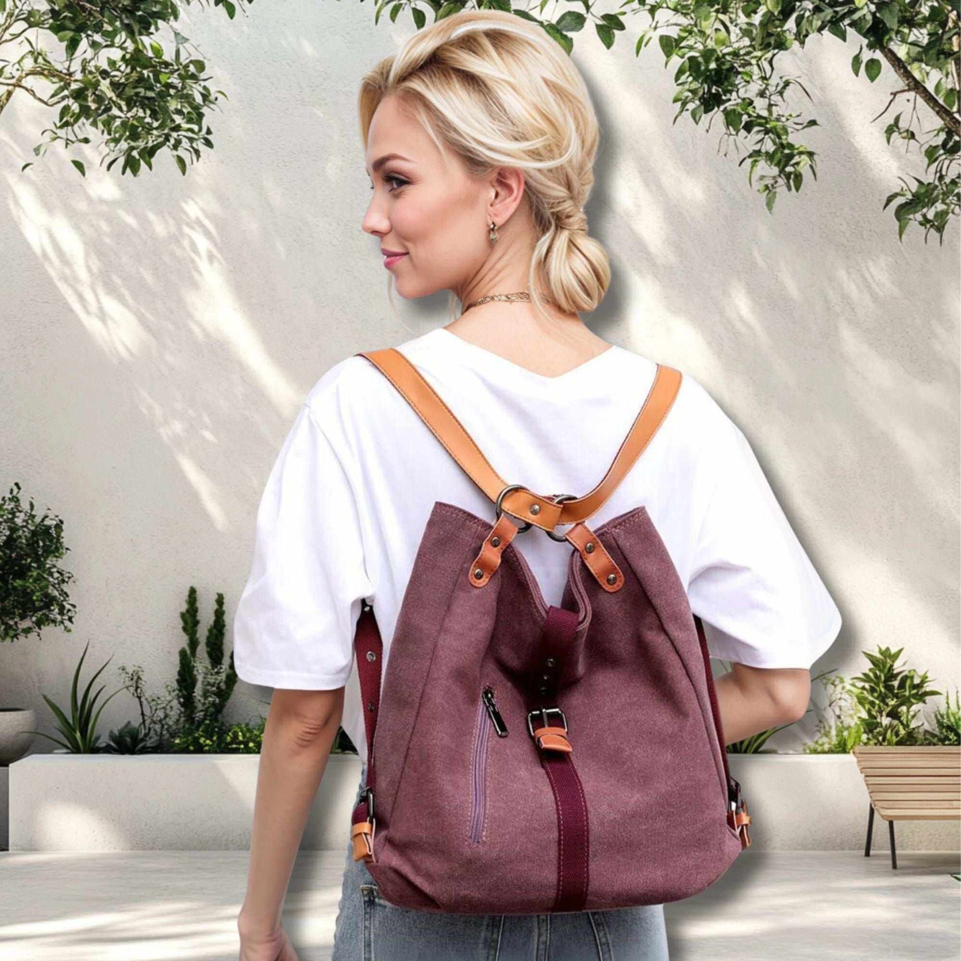 Woman wearing convertible backpack purse handbag with vegan leather accents, outdoor setting.