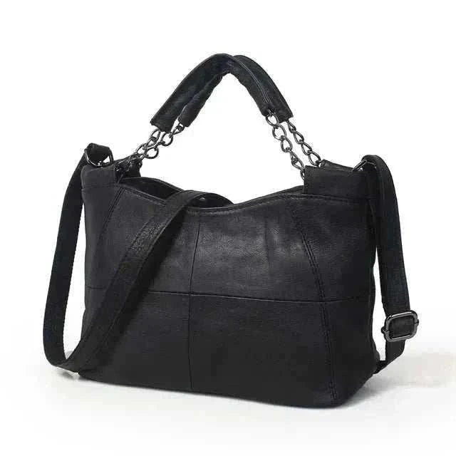 Soft black leather crossbody bag with chain-link handle and decorative stitching.