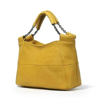 Yellow crossbody soft leather bag with chain-link handle from the Essence of Elegance Handbag Collection.