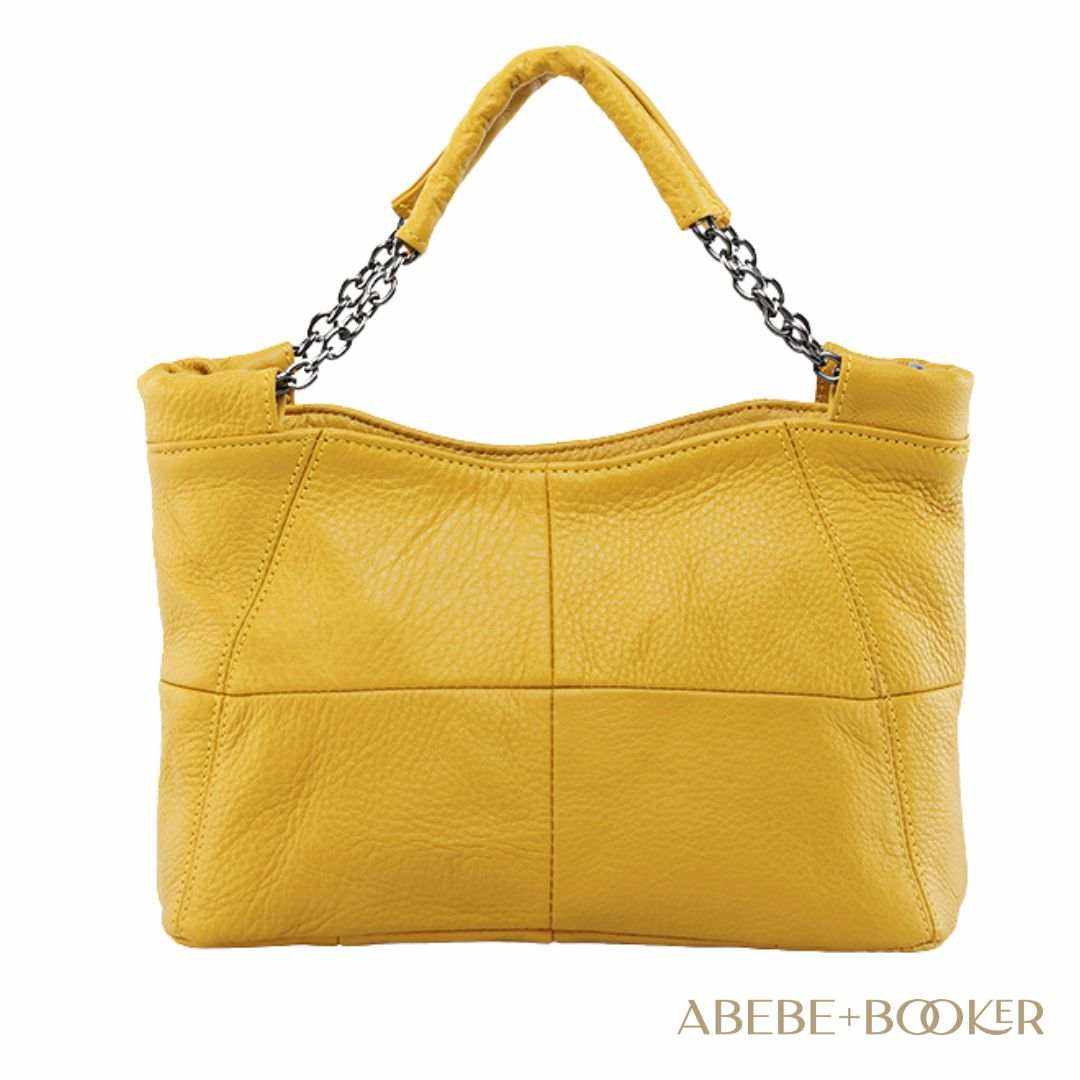 Yellow crossbody soft leather bag with chain-link handle and decorative stitching from Essence of Elegance Handbag Collection.