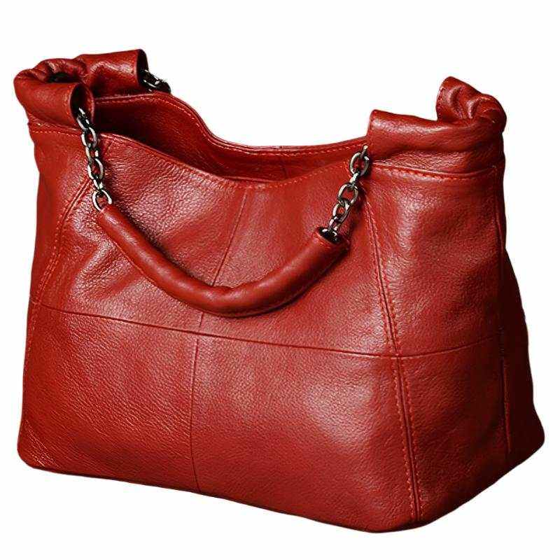 Red crossbody soft leather bag with chain-link handle and decorative stitching.