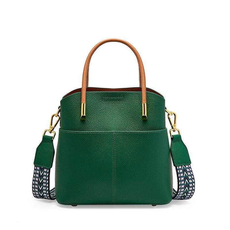 Green crossbody bucket handbag with leather finish and interchangeable straps.