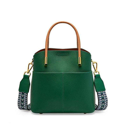 Green crossbody bucket handbag with leather finish and interchangeable straps.