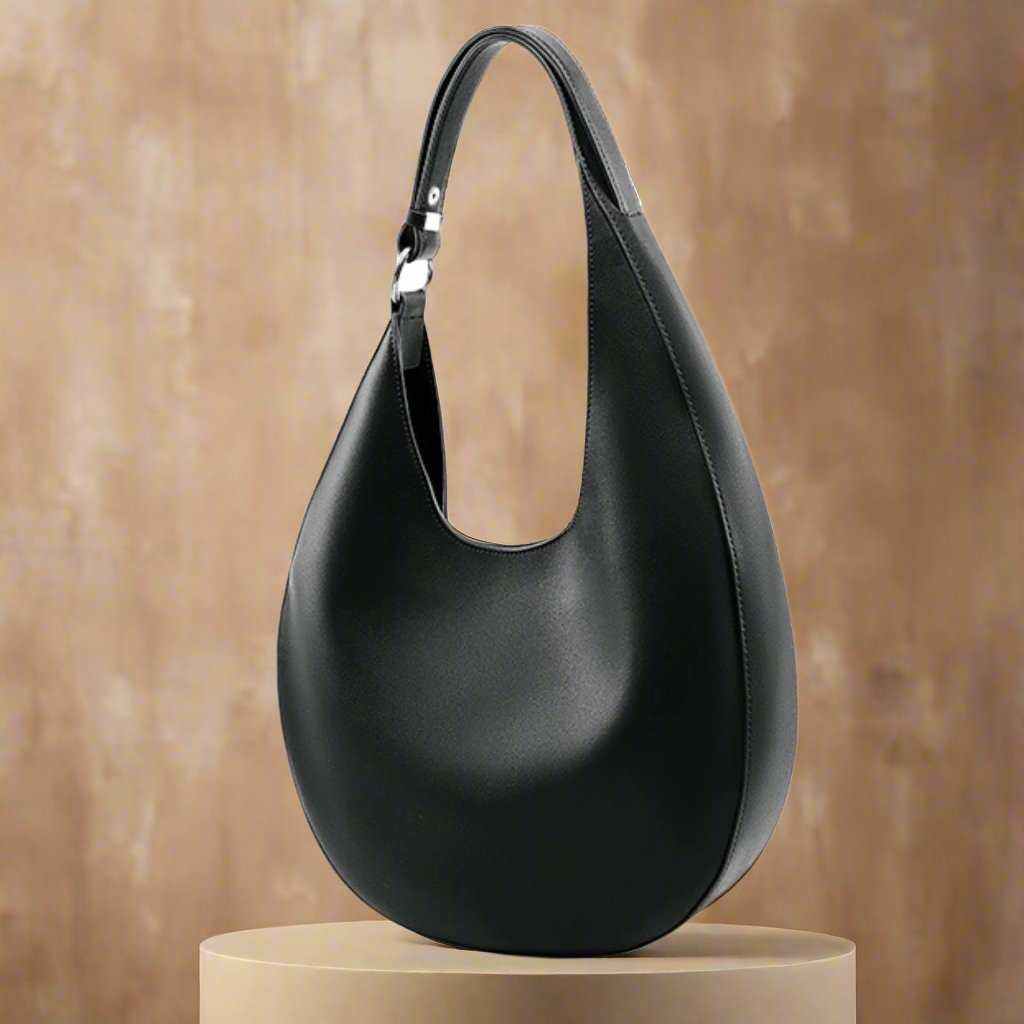 Crossbody Saddle Purse in black leather on display, from Essence of Elegance Handbag Collection.