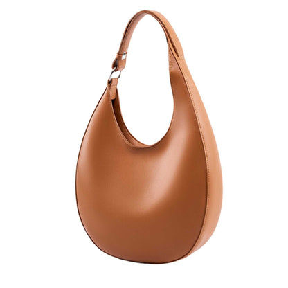 Tan leather crossbody saddle purse with an adjustable strap.