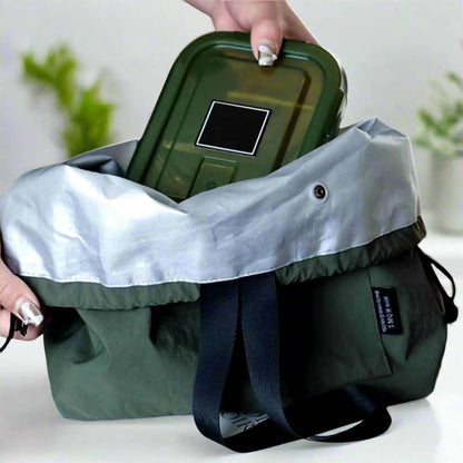 Insulated lunch pouch with drawstring closure, holding a container, durable canvas, PVC insulation.