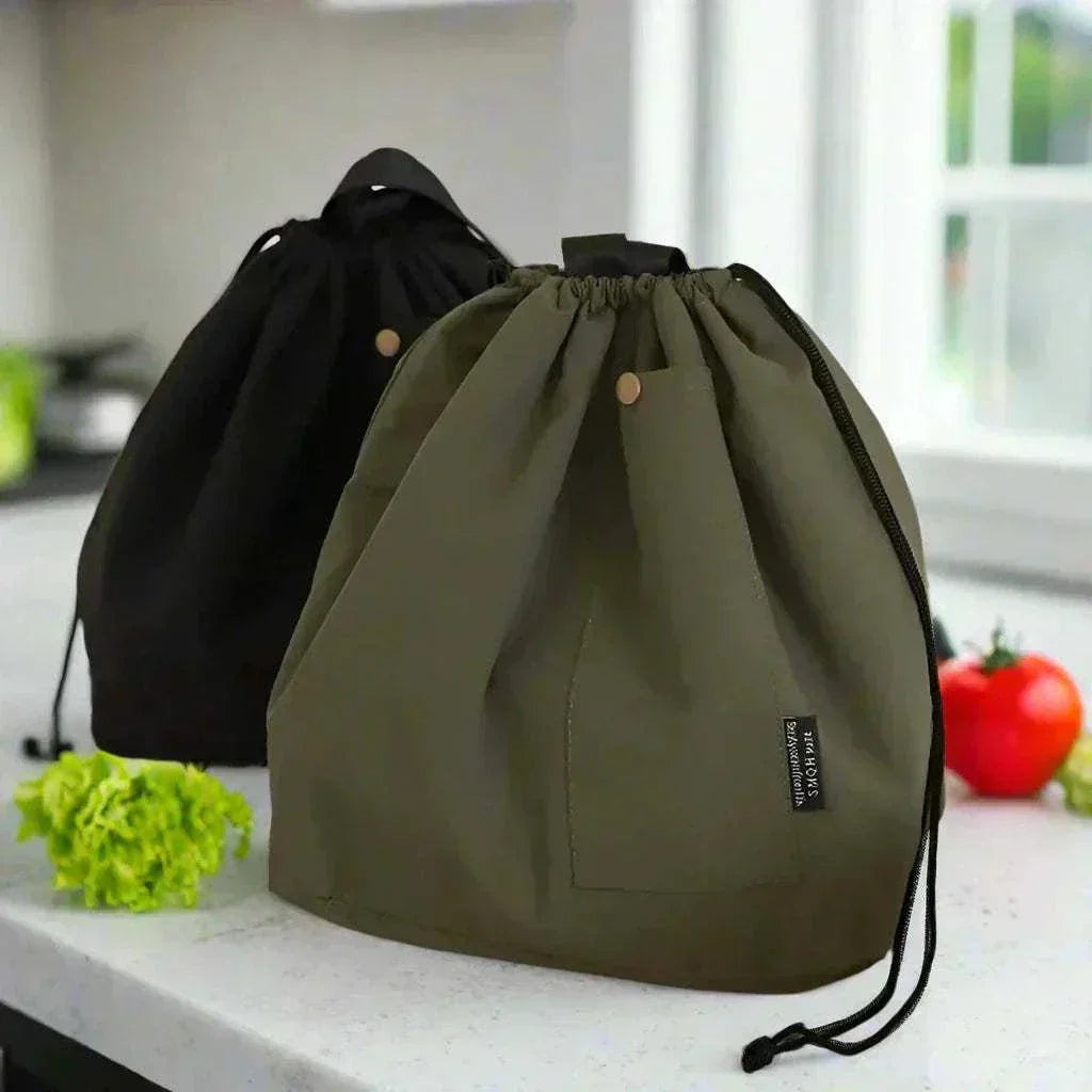 Insulated lunch pouch in green and black with drawstring closure on kitchen counter.