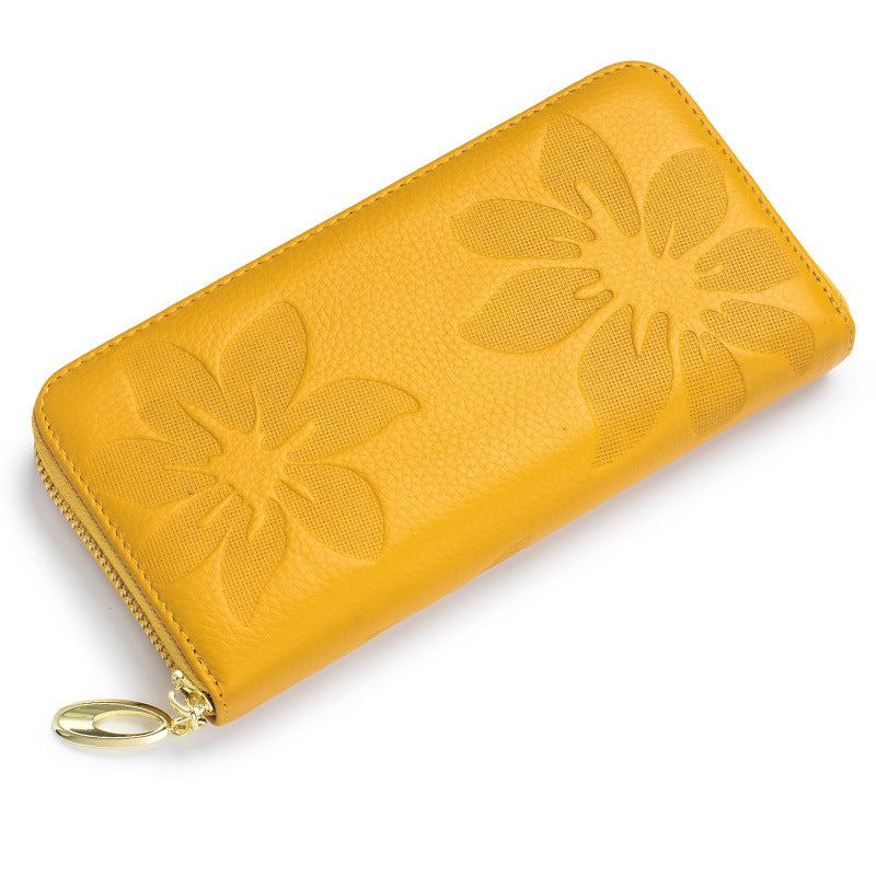 Yellow ladies leather wallet with embossed floral design, featuring a zip closure and compact size.