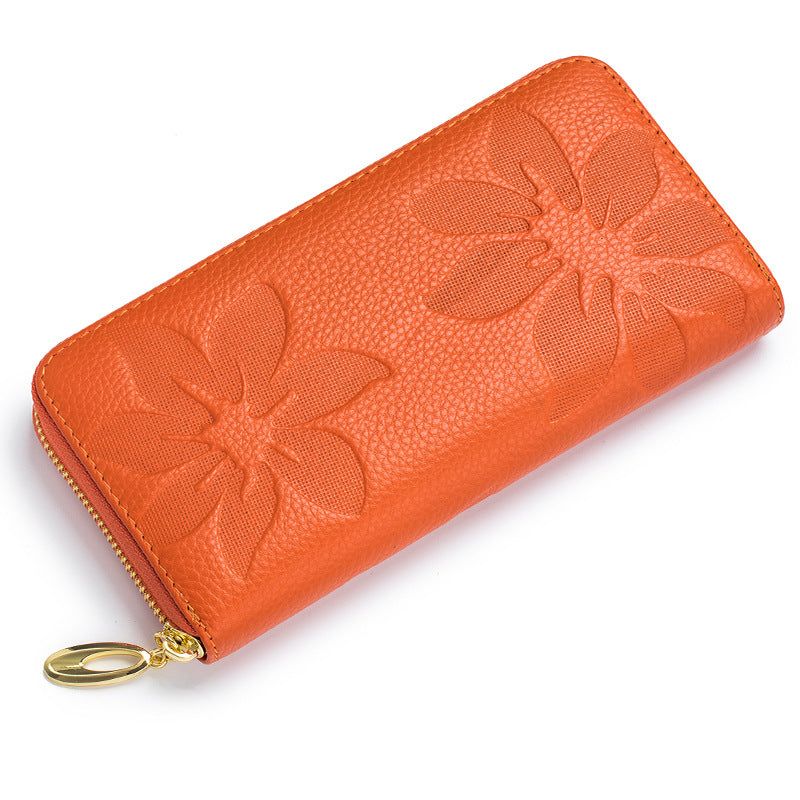 Ladies leather floral wallet in vibrant orange with embossed flower design.