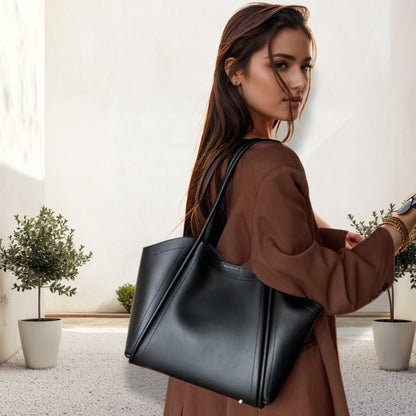 Elegant woman with Ladies Leather Tote in sleek black design.