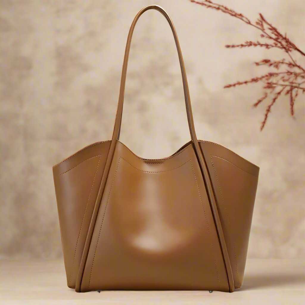 Ladies Leather Tote with elegant, sleek design and rolled leather straps on a neutral background.