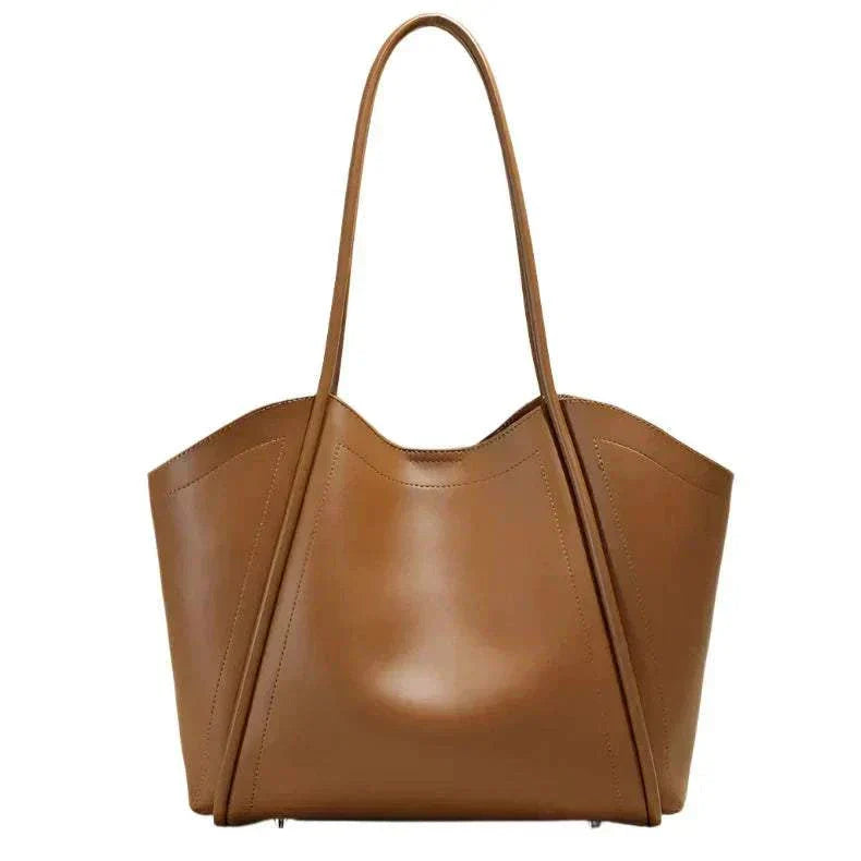 Ladies Leather Tote with sculpted design and rolled leather straps.