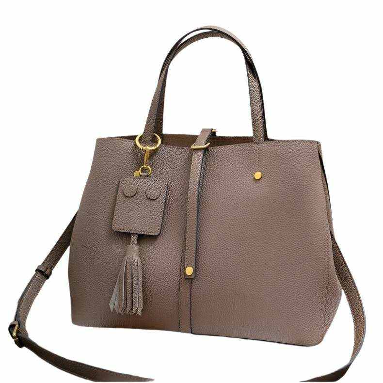 Ladies leather work bag with tassel, versatile design, genuine leather, Essence of Elegance Handbag Collection.