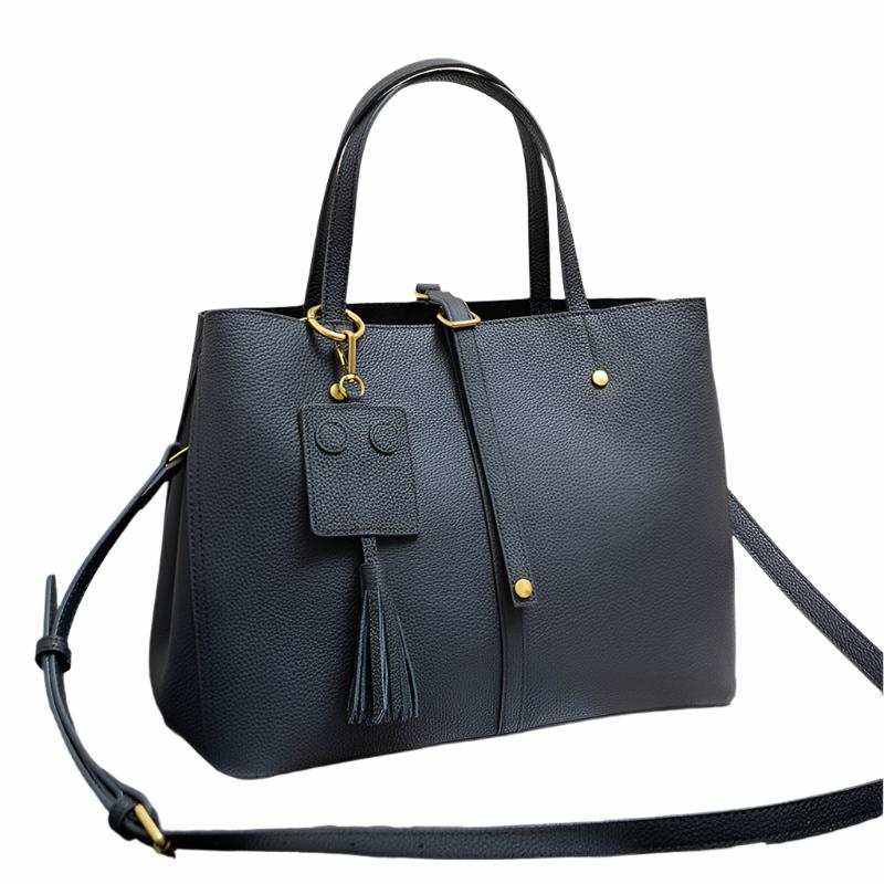 Ladies Leather Work Bag with tassel, versatile design, spacious interior, and genuine leather material.