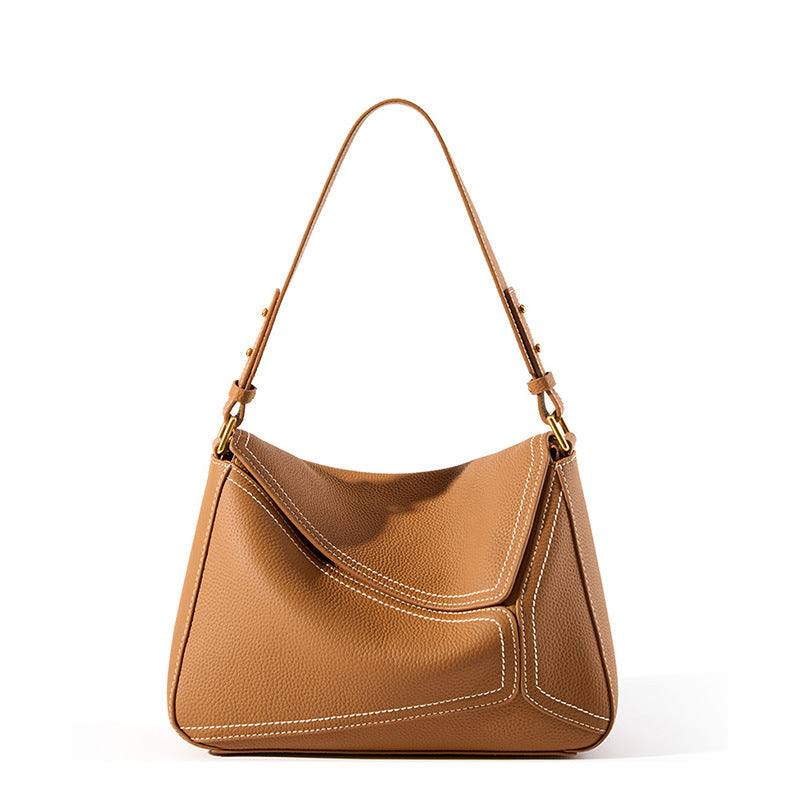 Ladies small shoulder bag in genuine leather, featuring adjustable strap and lychee pattern design.