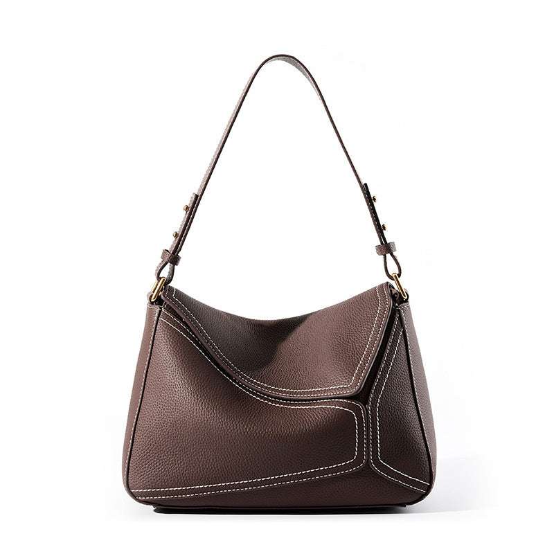 Ladies small shoulder bag in genuine lychee-pattern leather with adjustable strap and multiple pockets.