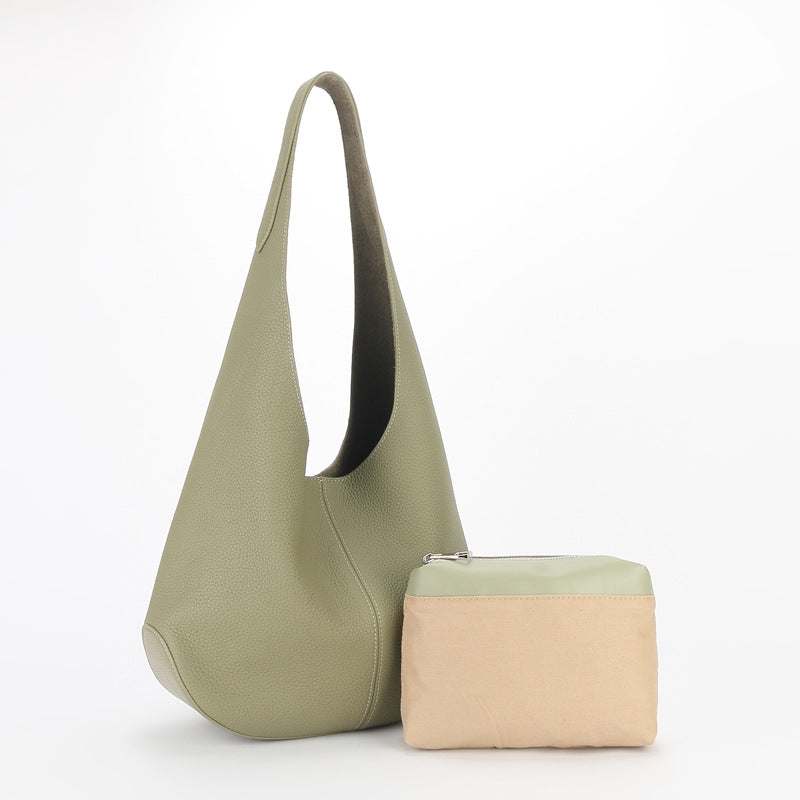 Large leather tote bag with a simple, relaxed design, featuring genuine leather construction in a soft green color, ideal for everyday use.