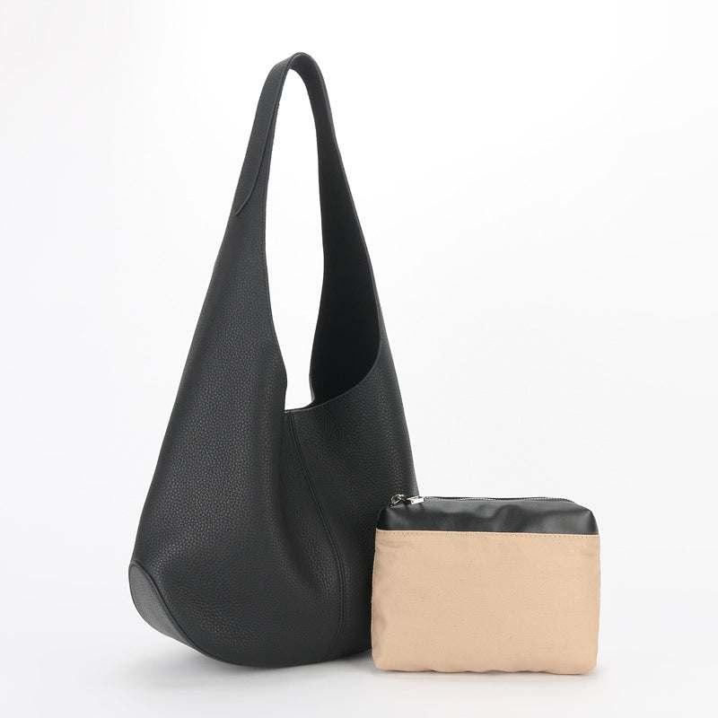 Large leather tote bag with black finish, spacious interior, and additional pouch.