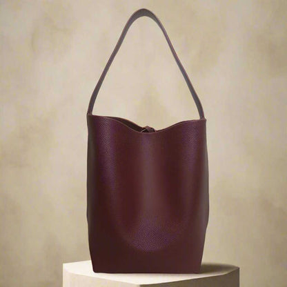 Iconic Leather Bucket Bag Lychee with lychee pattern and spacious design.