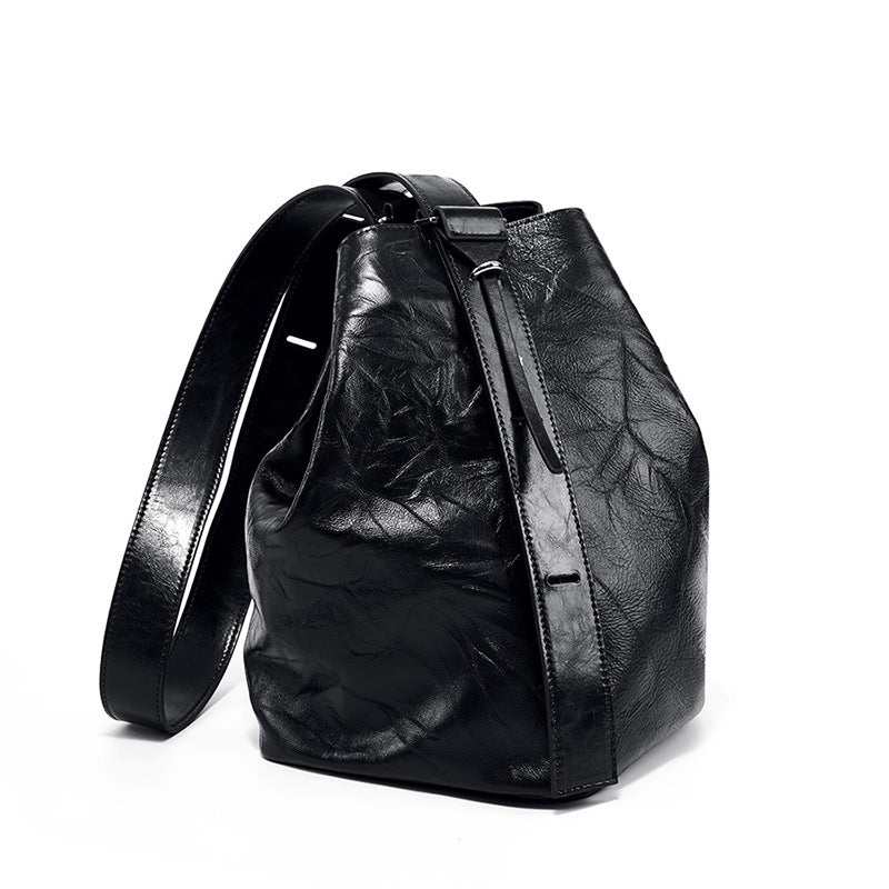 Black leather convertible backpack with adjustable straps and durable design.