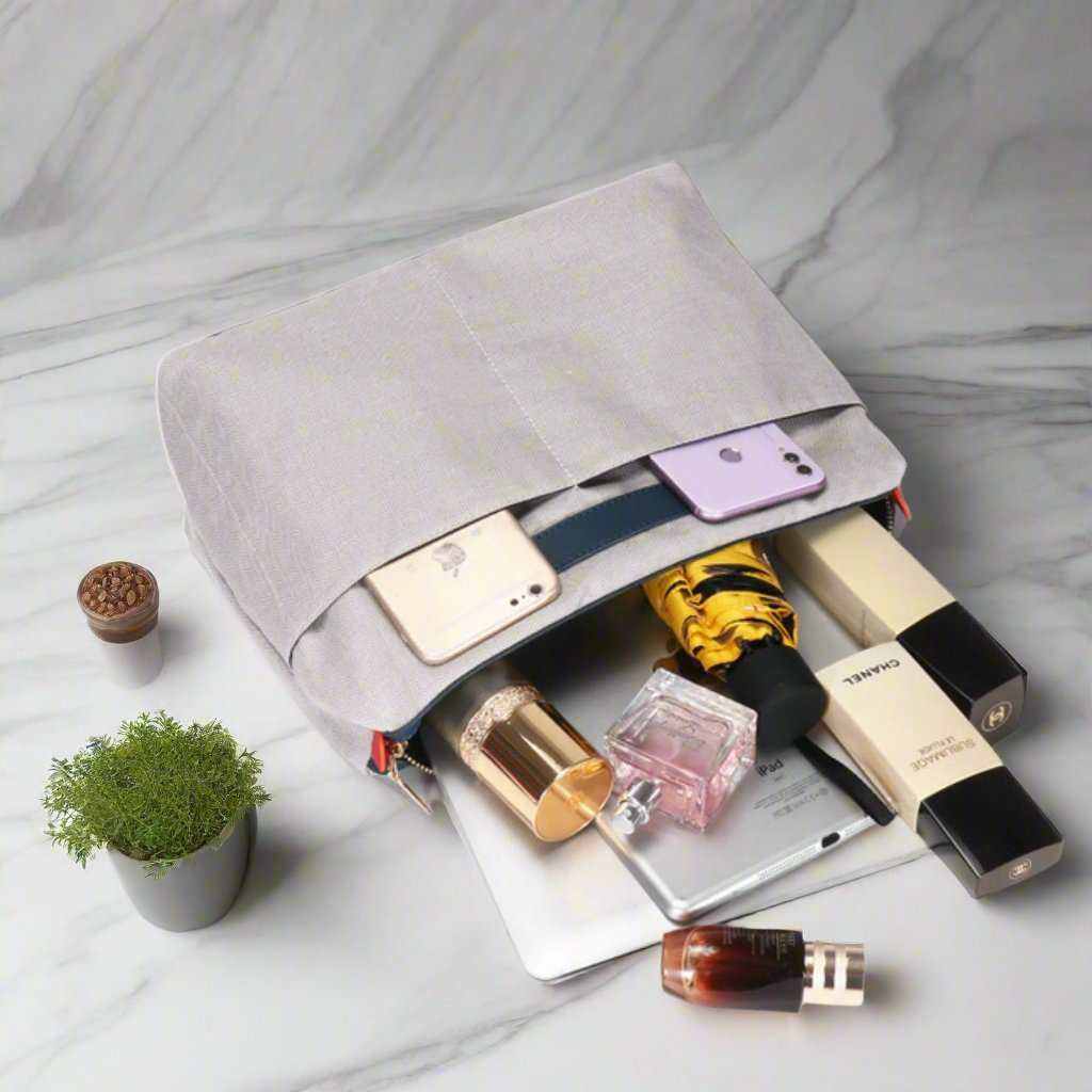 leather handbag blue with personal items displayed, showcasing storage capacity on a marble countertop