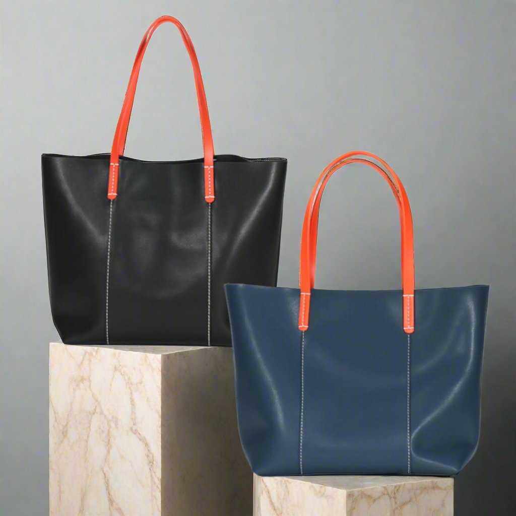 Blue and black leather handbags with orange straps on display.