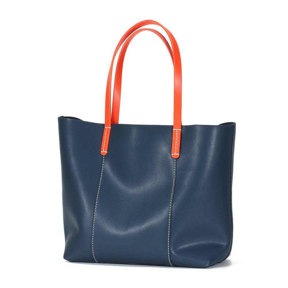 Blue leather handbag with carrot-colored straps from the Essence of Elegance Handbag Collection.