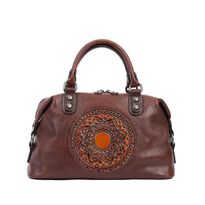 Genuine leather retro bag with embossed medallion design and rolled handles.