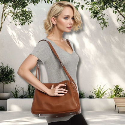 Woman carrying a brown Leather Satchel Purse in an outdoor setting.