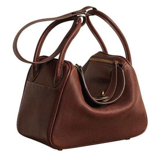 Brown leather satchel purse with dual handles and zipper closure.