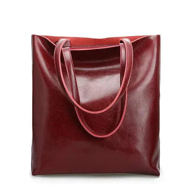 High-quality genuine leather shoulder bag in elegant reddish-brown color with sleek design, ideal for casual and professional use.