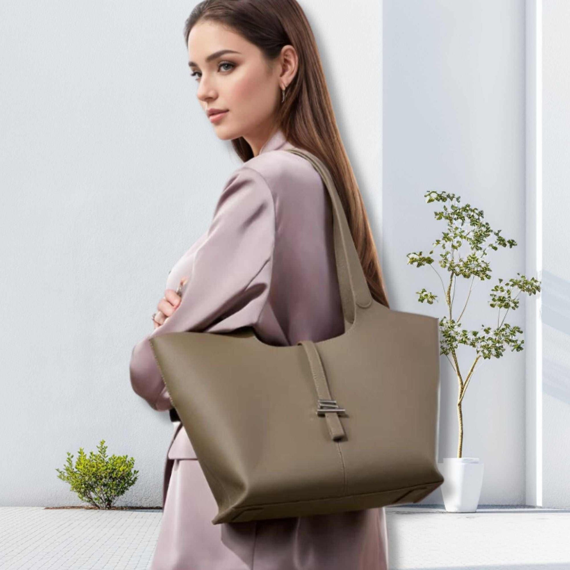 Woman carrying a Leather Tote Purse with Zipper in refined Elephant Gray, showcasing its modern concave design for stylish elegance.