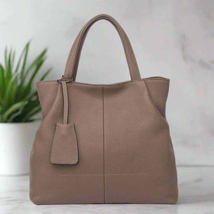 Leather tote zipper handbag made from genuine leather with spacious interior and elegant design.